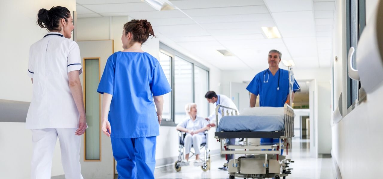 Hospital staff discussing patient care and the patient assignment process in the morning.